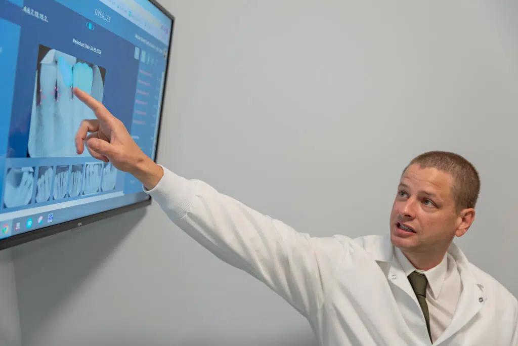 Our Troy dentist talking to a patient about root canal treatment