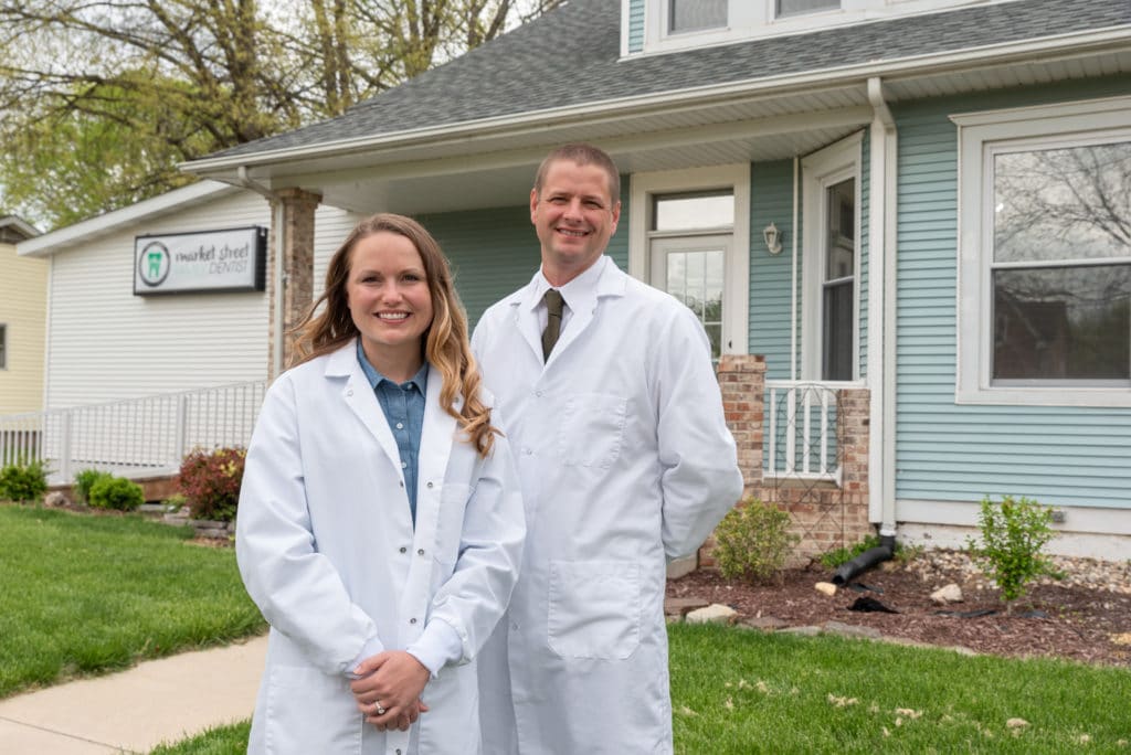 Dentists in Troy, IL standing in front of their dental office