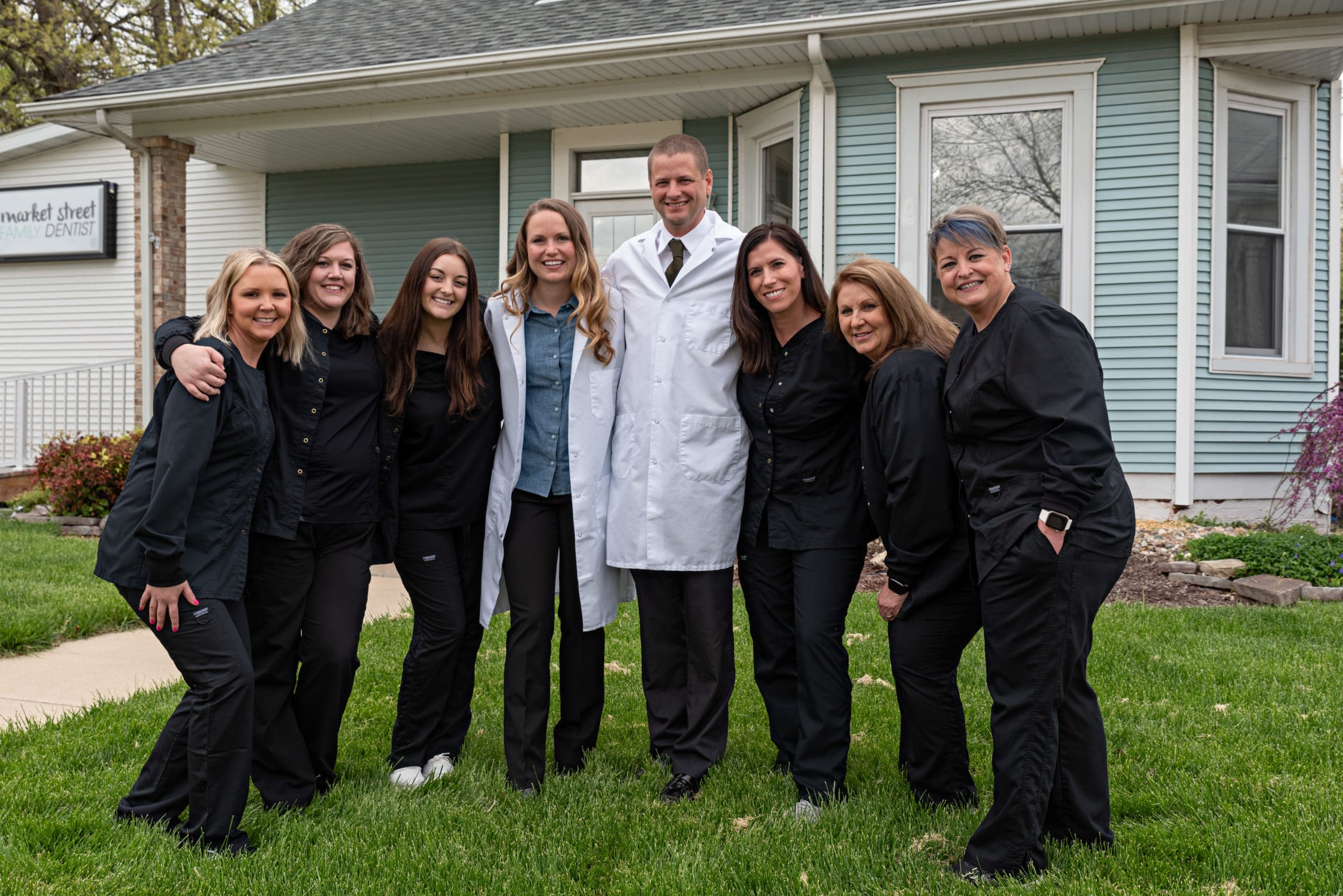 Group picture of our Troy dental team with our top-rated dentist in Troy in the middle.
