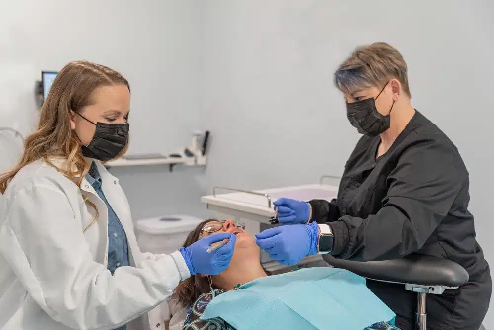 Dr. Petrich performing a dental exam and cleaning on a patient in Troy, IL
